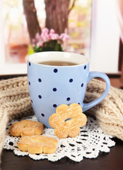 cup of tea with scarf on table in room