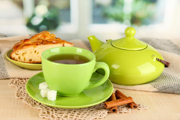 cup of tea with scarf on table in room