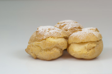 three cream puffs with sugar & white background & path - DSC0777