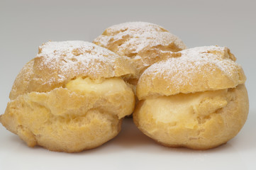 three cream puffs with sugar & white background & path - DSC0767