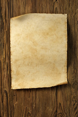 aged paper sheet on aged dark wood