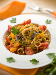 spaghetti with pumpkin anchovy caper  tomatoes, selective focus