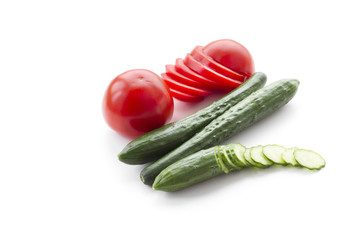 Tomatoes and cucumbers on a white background.