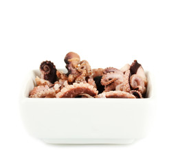 Tentacles of octopus in bowl isolated on white