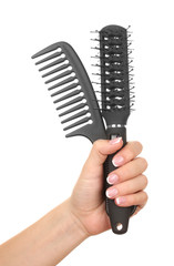 Obraz premium Three combs in female hand, isolated on white