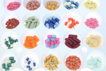 Assortment of pills and capsules of colours. Medication varied s