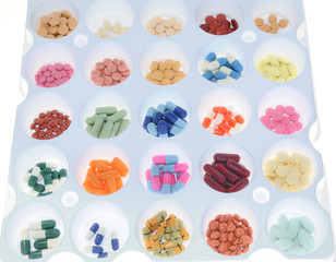 Assortment of pills and capsules of colours. Medication varied s