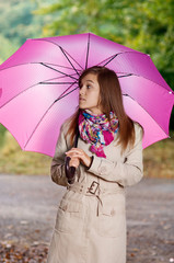 Cute young woman with umbrella
