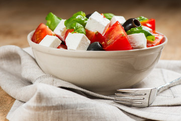 Greek salad in bowl on napkin