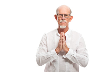 Spiritual senior man with glasses. Isolated on white.
