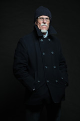 Good looking senior man winter fashion. Studio shot.