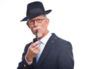 Well dressed senior man with glasses smoking pipe. Isolated.