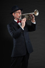 Senior jazz musician. Trumpet player. Studio shot.