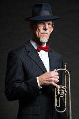 Senior jazz musician. Trumpet player. Studio shot.