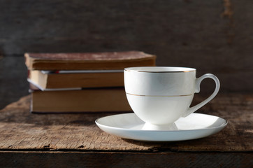 White circle on a wooden table with books