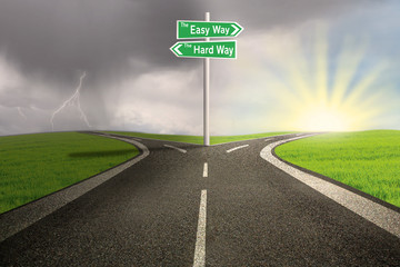 Road sign of easy vs hard way on highway
