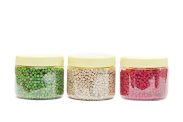 Red, green and white peppercorns isolated on white background