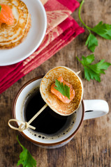 Pancakes with salted salmon with a Cup of coffee