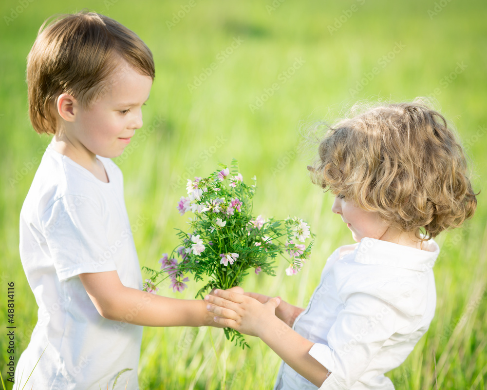 Wall mural smiling boy giving bouquet