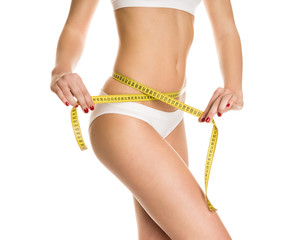 Athletic girl measuring figure meter