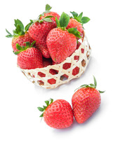 strawberries in woven basket on white