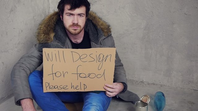 unemployment homeless designer sittin on the floor and asking fo