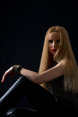 Studio portrait of beautiful young sexual rock woman in stylish