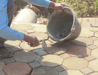 Close-up of men hand holding a trowel, applying mortar