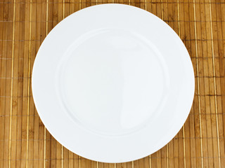 white plate on a bamboo napkin