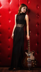 Fototapeta na wymiar Elegant woman in black with guitar
