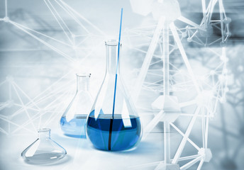 Big laboratory flask on abstract science background