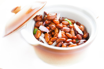 brown beans with onion in a ceramic pot