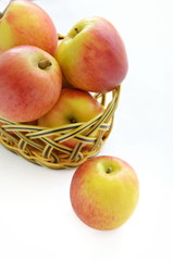 Apples in basket isolated on a white