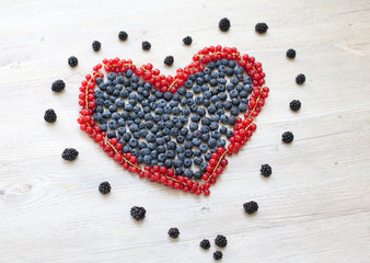 Heart made with red currant berries and blueberries