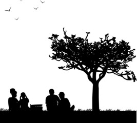 Family picnic in park in spring silhouette