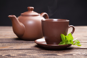 Tea with mint on a wooden table