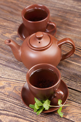Tea with mint on a wooden table