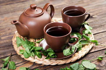 Tea with mint on a wooden table