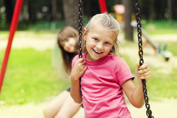 Happy little girl on swing