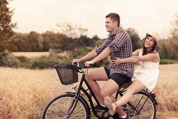 Couple have fun riding on bike