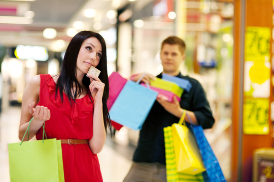 Young woman spending too much money for shopping