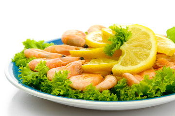Boiled shrimps with lemon and lettuce leaves