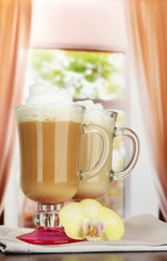 Fragrant coffee latte in glasses cups with vanilla pods,