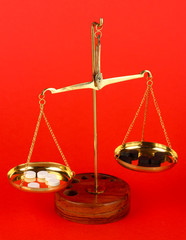 Classic scales with color pills on color background