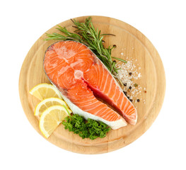 Fresh salmon steak on cutting board, isolated on white