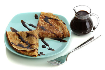 Sweet pancakes on plate with condensed milk isolated on white