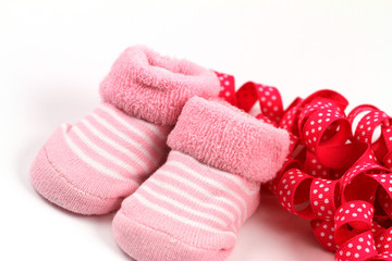 Pink baby socks and pink ribbon