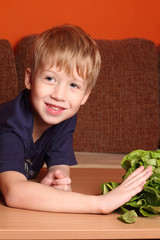 Cute little boy with a salad