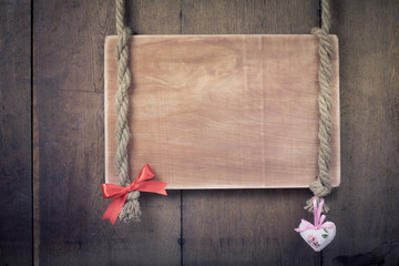 Valentine wooden signboard on rope with heart and bow