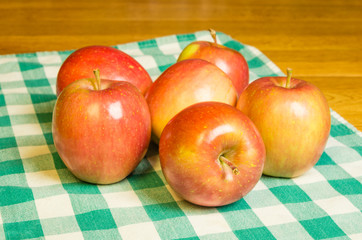 Fresh Fuji apples on a checked cloth